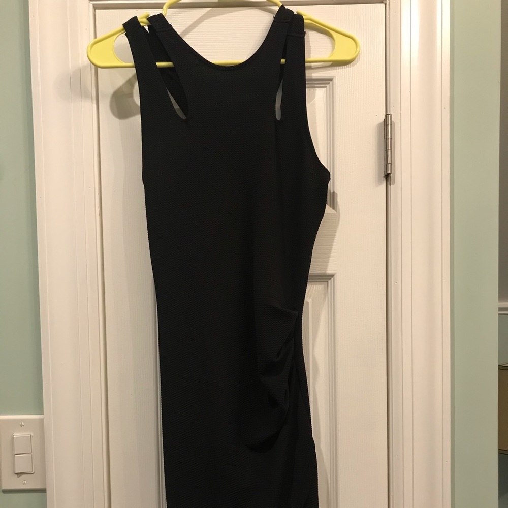 Form fitting black dress with asymmetrical straps